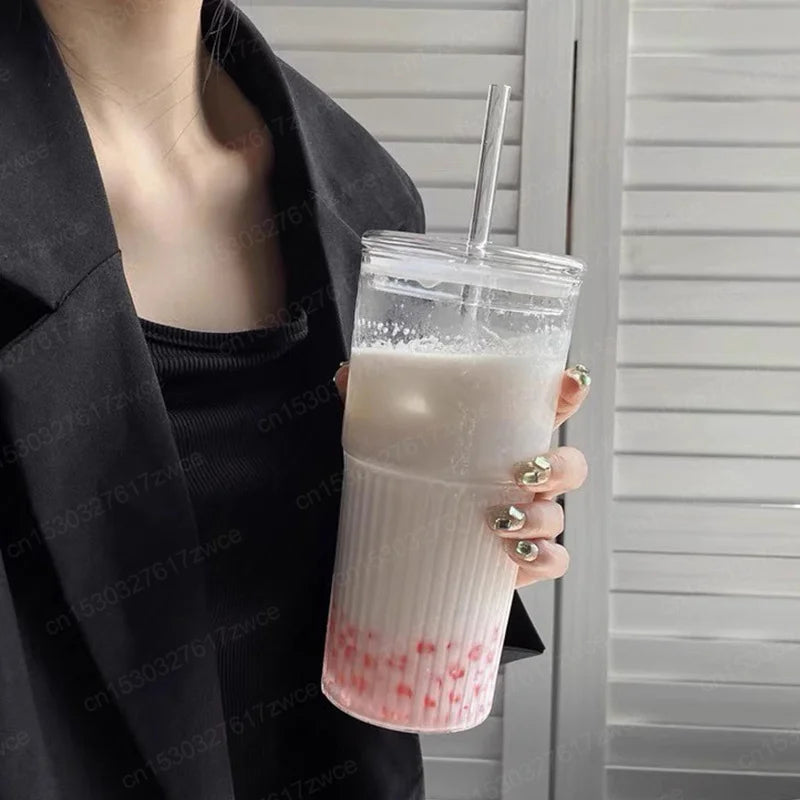 A girl holding boba tea in glass tumbler 