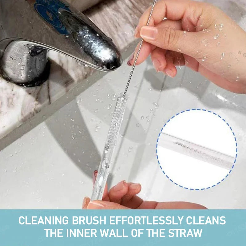 Close-up of a cleaning brush being used to clean a glass drinking straw under running water. 